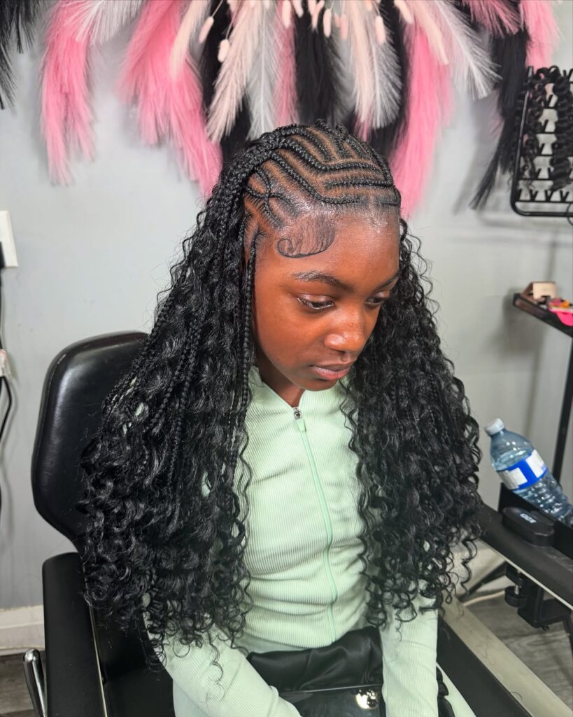 Cornrow braided top with long wavy braids flowing down the back.