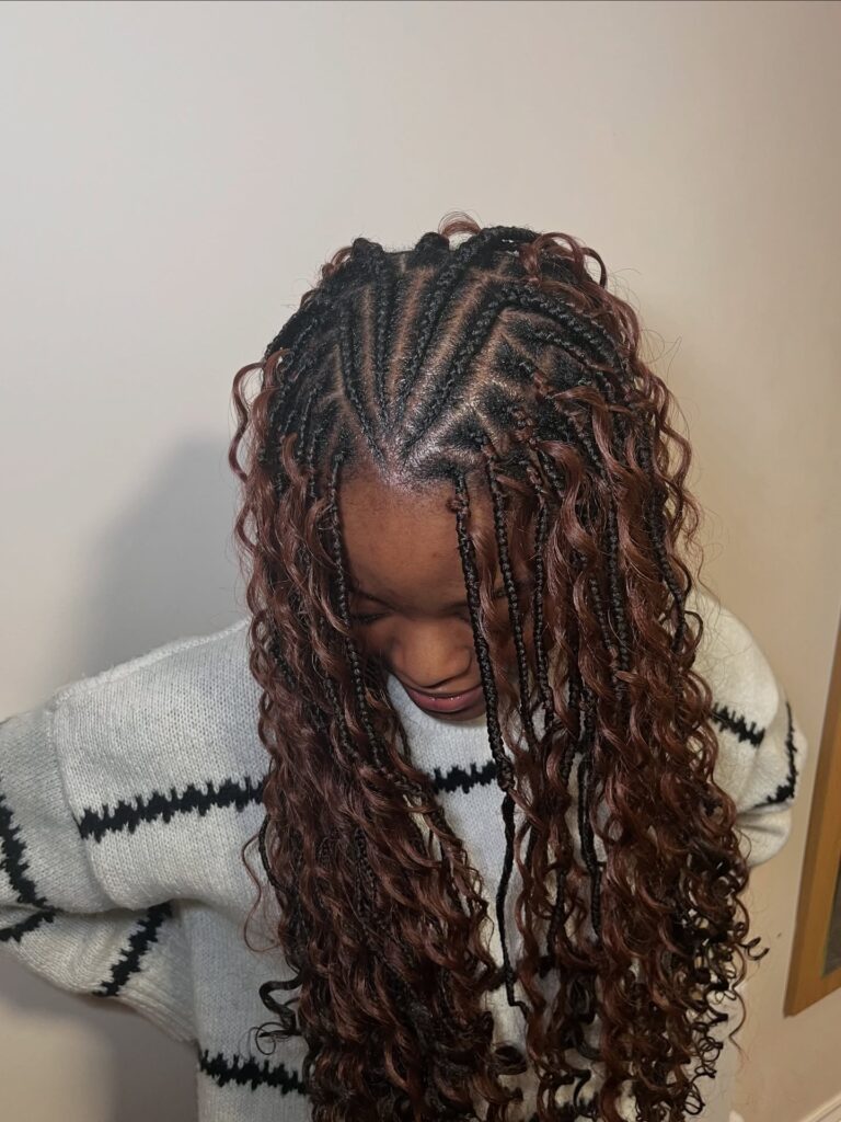 Medium braids with loose curls and soft brown highlights throughout.