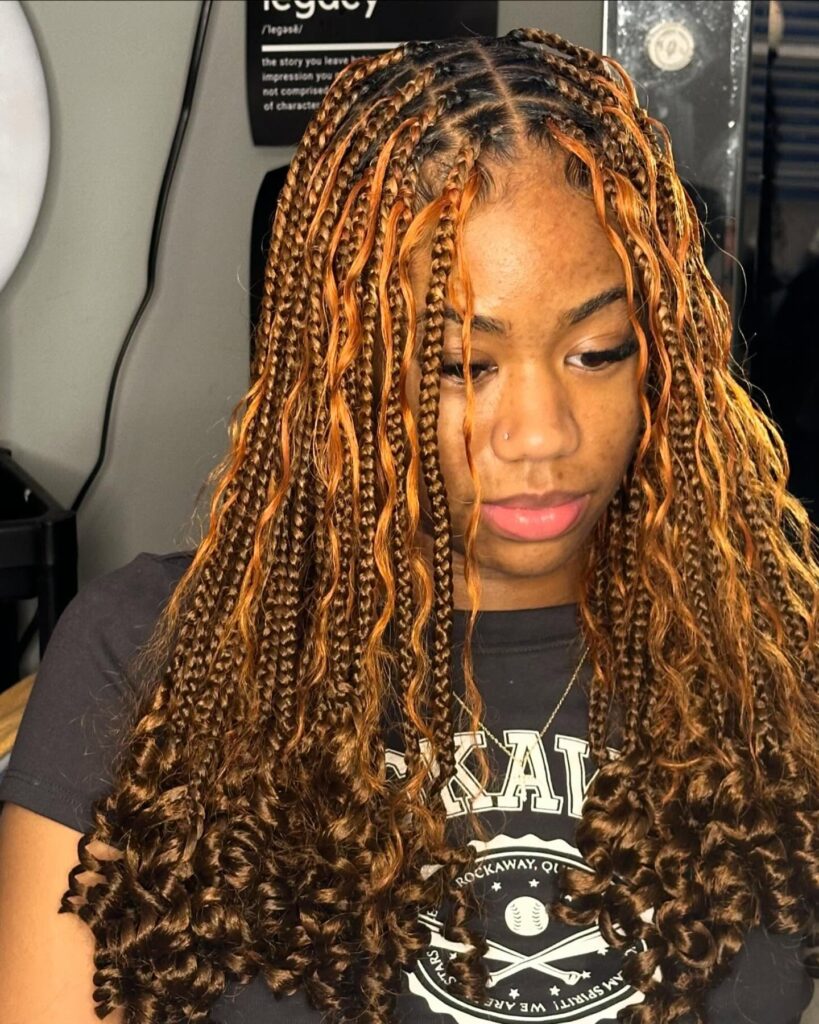 Copper and brown braids with curly spiral ends creating a warm and voluminous look.
