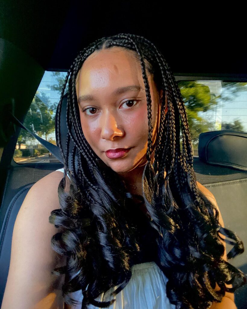 Middle part braids with soft wavy ends for a smooth and flowing look.