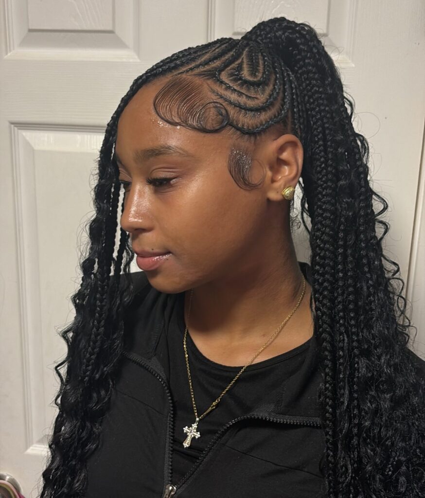 Half up braided ponytail with tribal parting and sleek styled baby hairs.