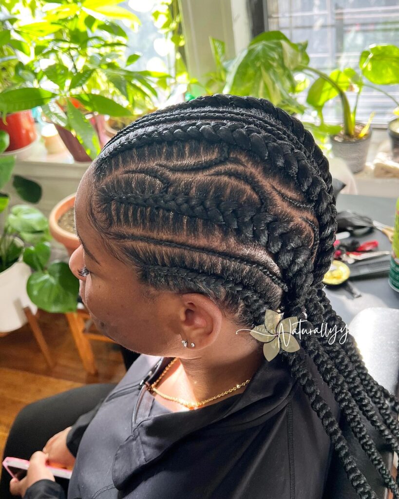 Neat feed in cornrows braided back into a long ponytail with clean parts.