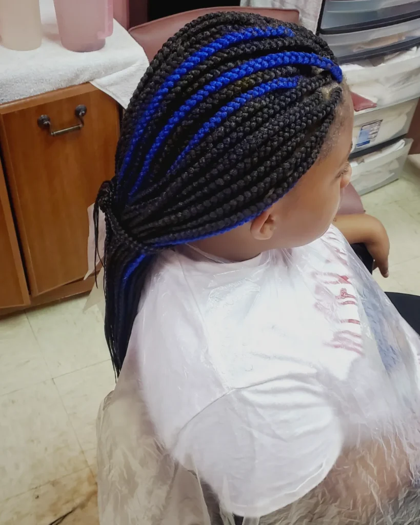 Black cornrow braids with bright blue highlights styled neatly along the scalp.