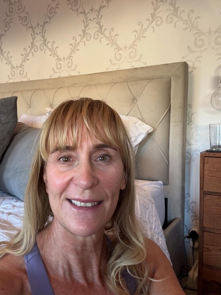 Medium length blonde hair with blunt bangs and soft layers.