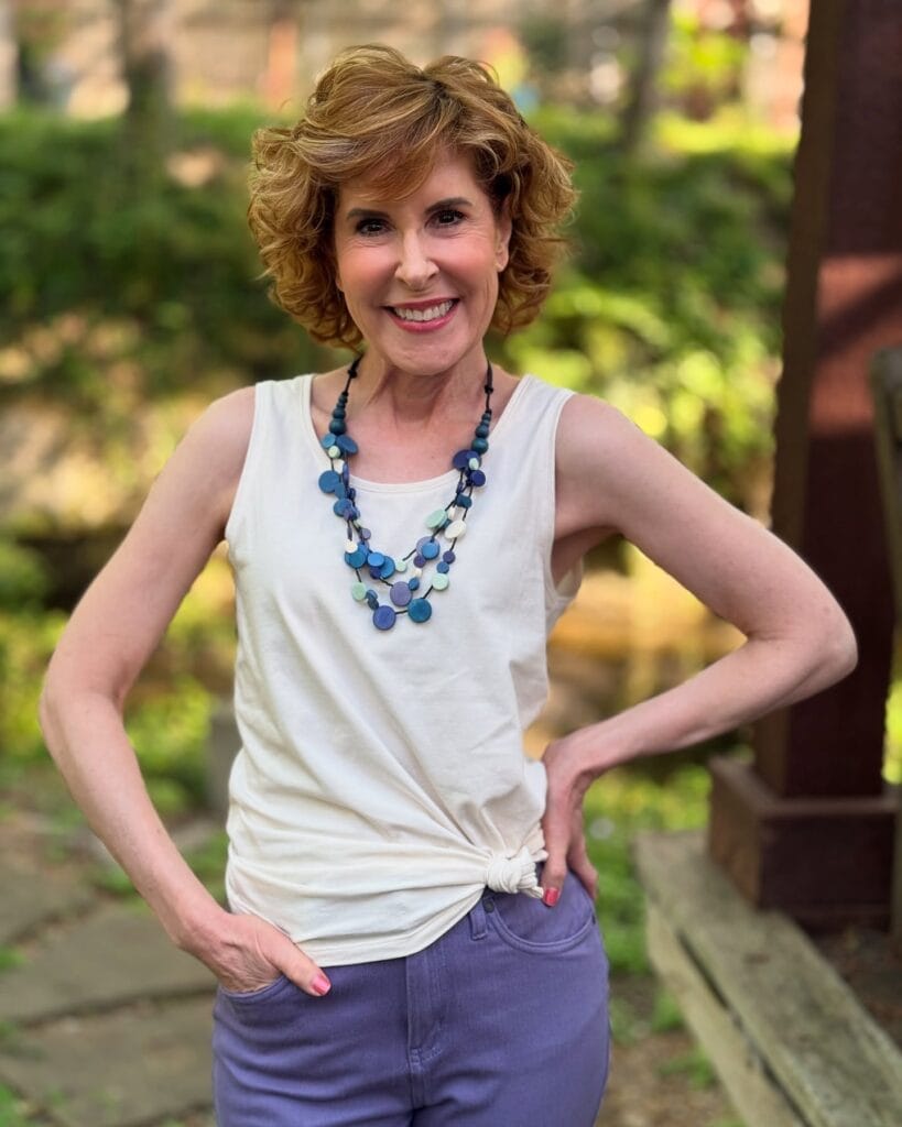 Short layered blonde haircut with a soft fringe and light volume.