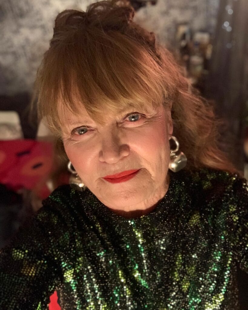 Soft updo with curtain bangs and loose face framing pieces.