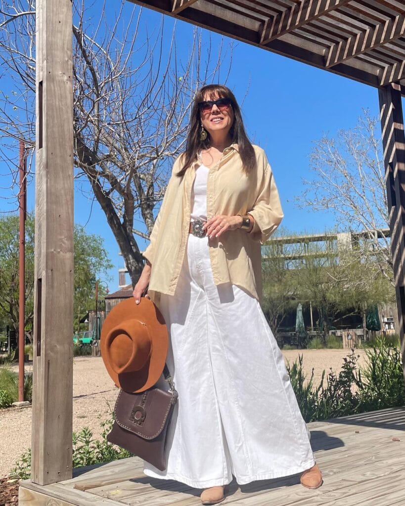 Long straight brunette hair with soft bangs and subtle layering.