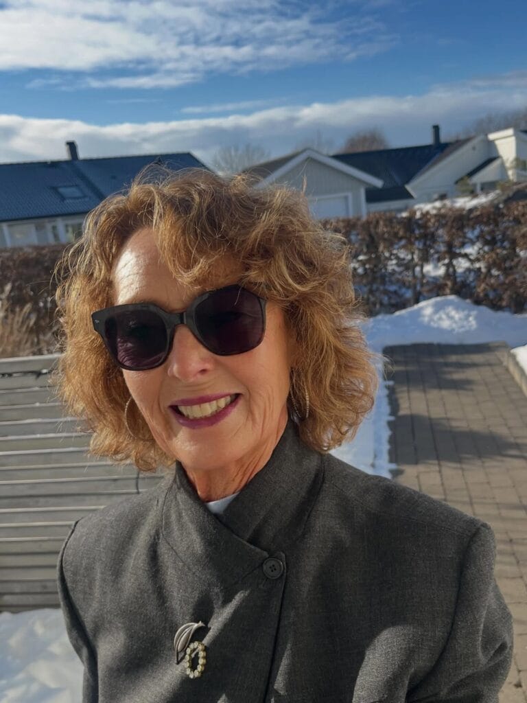 Short curly hair with textured bangs and natural volume.