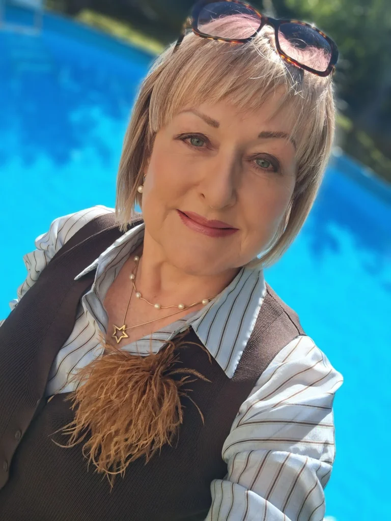 Short blonde layered haircut with a soft light fringe.