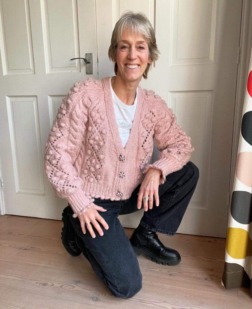 Short gray pixie cut with soft layers and side swept bangs.