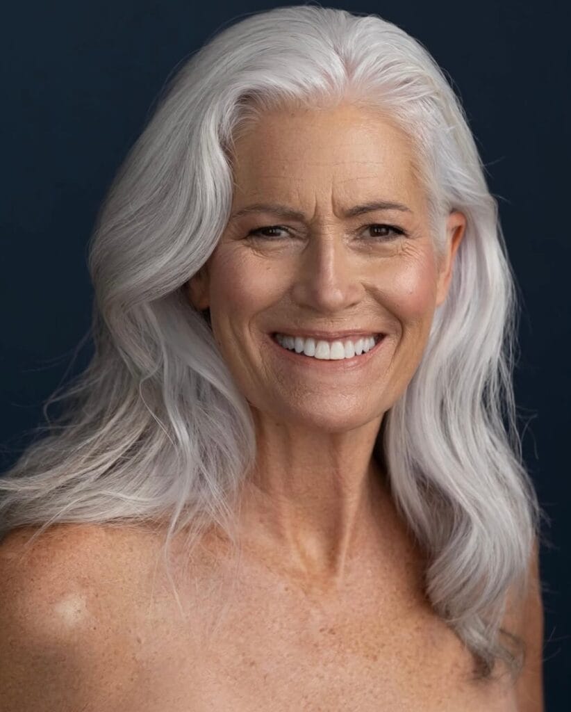 Long white wavy hairstyle with soft volume and a side part.