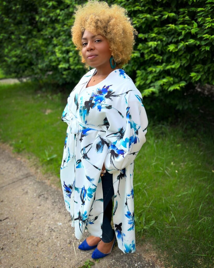 A woman with a medium short golden honey blonde kinky coily afro.