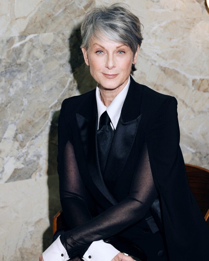 Short salt and pepper pixie haircut with soft layers and natural movement.