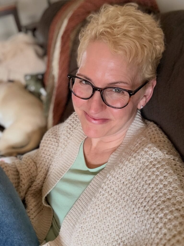 Short blonde pixie haircut with soft textured layers and a light tousled finish.