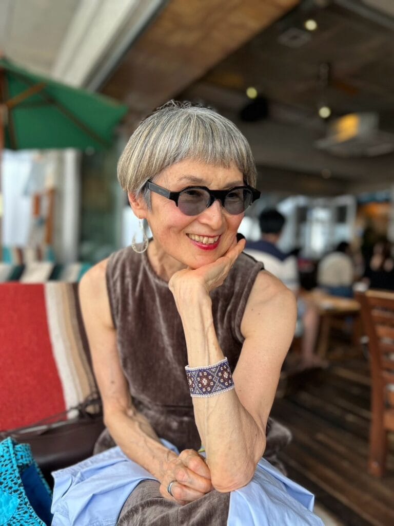 Short silver bowl pixie haircut with clean edges and a smooth rounded shape.