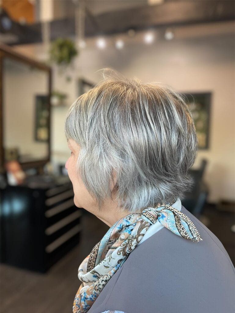 Short gray layered bob with a tapered back and soft movement.