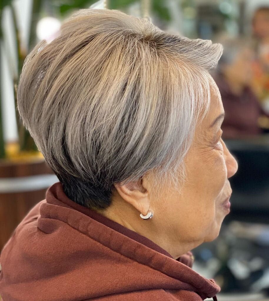 Short gray pixie haircut with soft layers and natural volume at the crown.