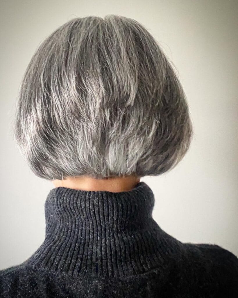 Rounded gray bob haircut with soft layers and full volume.