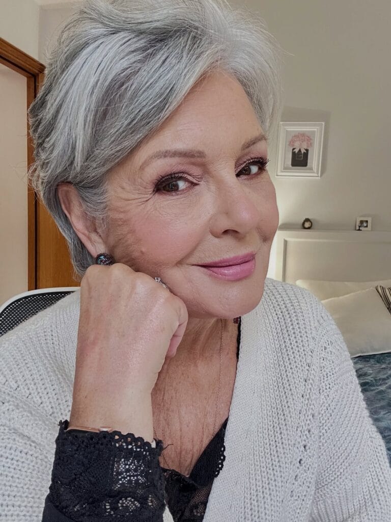 Short silver pixie haircut with soft layers and a side swept shape.