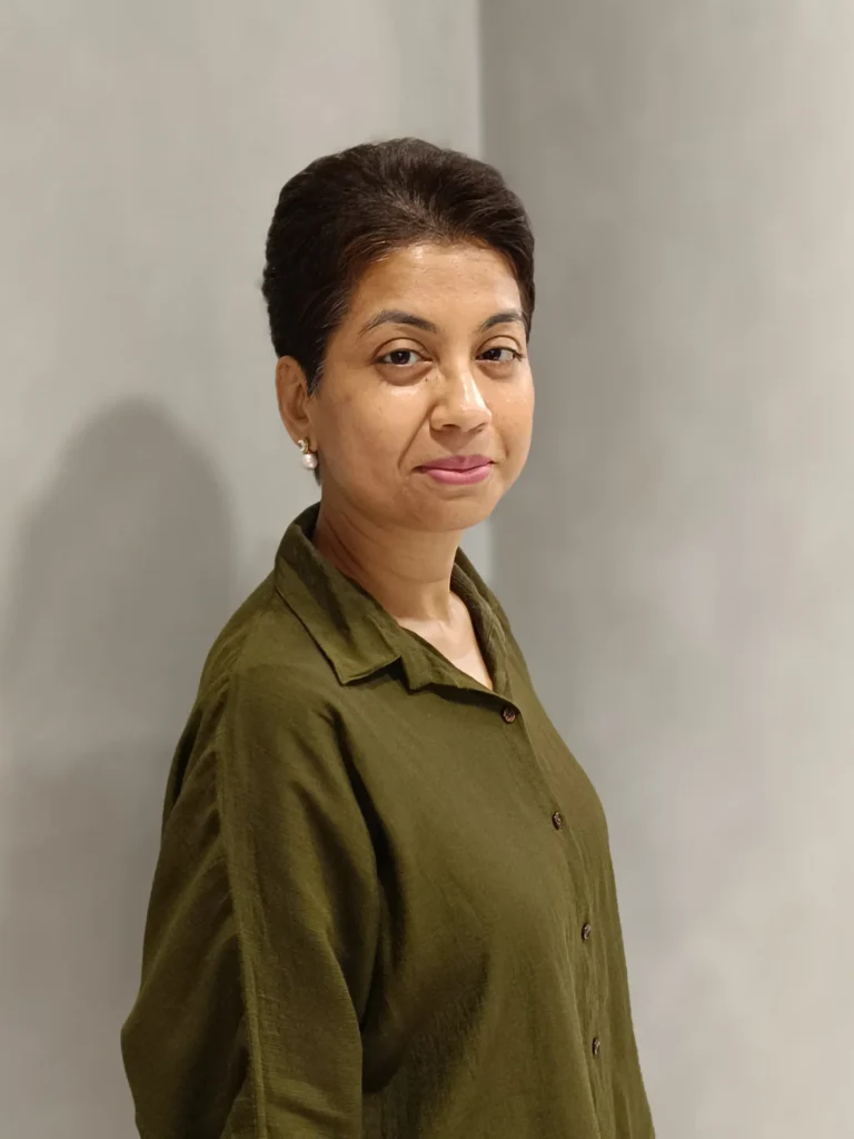 Short dark pixie haircut with smooth layers and neatly tucked sides.