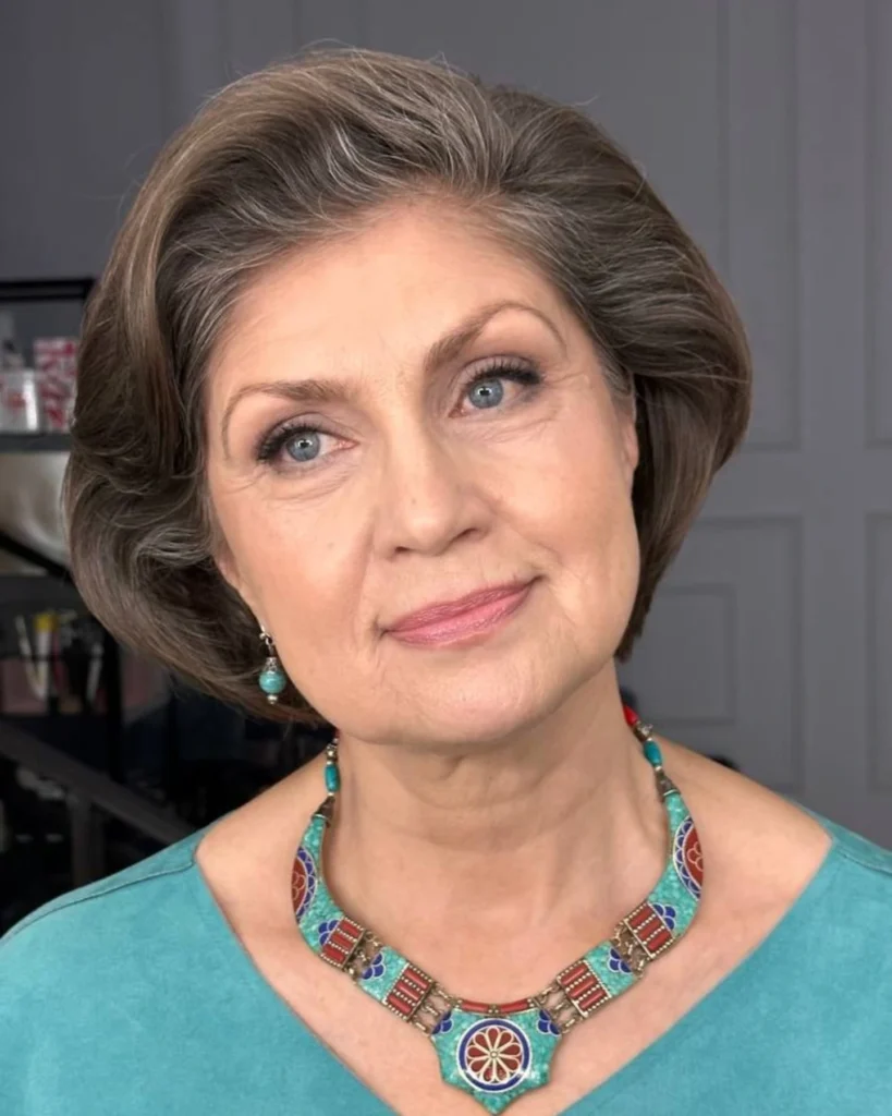 Short to medium brunette layered hairstyle with a rounded shape and smooth texture.