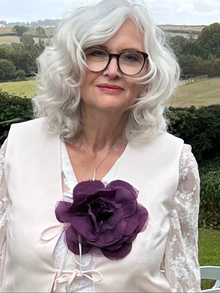 White curly bob with soft volume and a rounded shape.