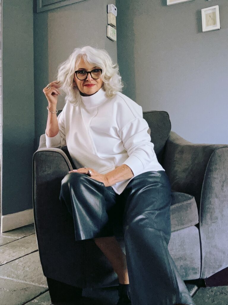 Shoulder length silver hair with soft waves and a natural center part.