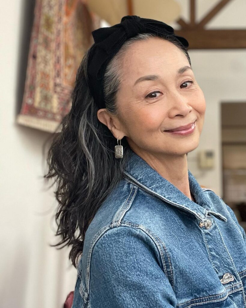 Long wavy hairstyle styled half up with soft volume and natural flow.