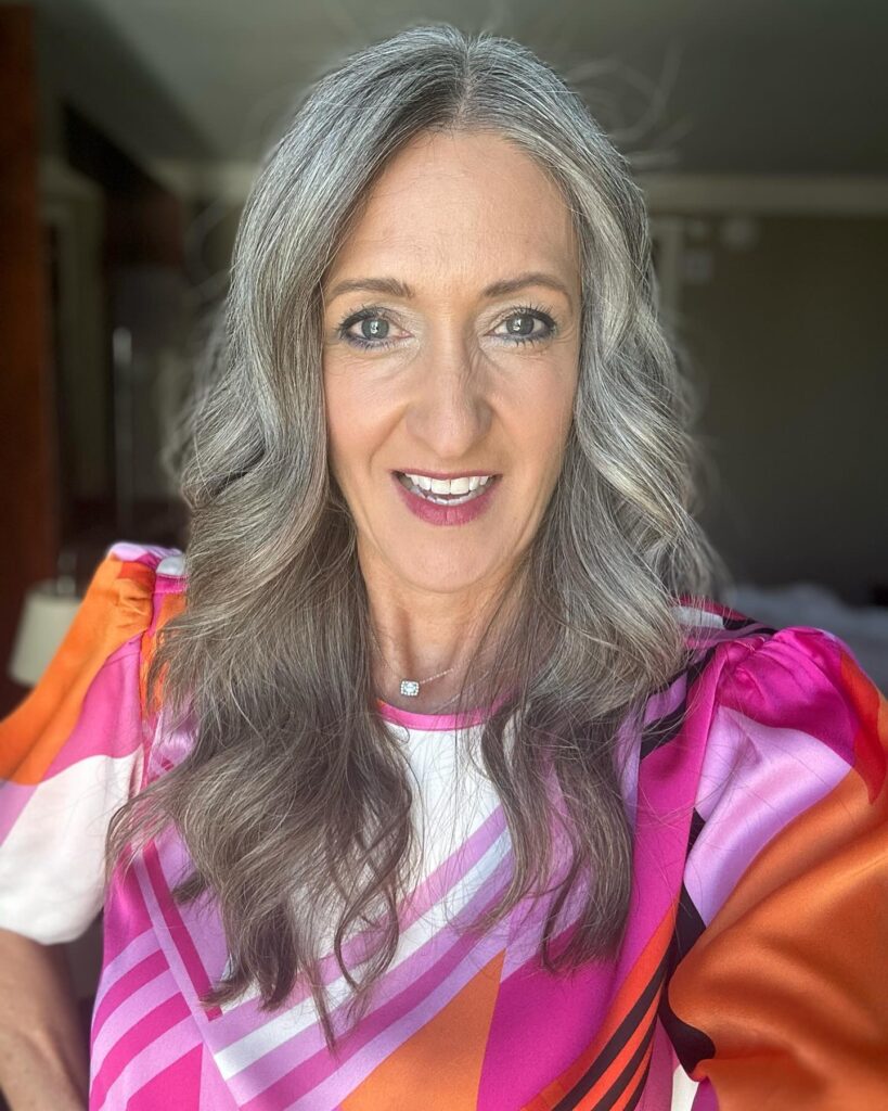 Shoulder length silver wavy hair with soft layers and natural movement.