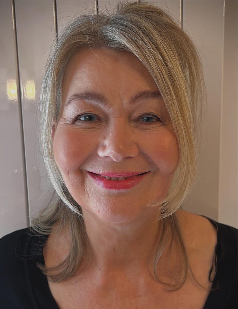 Chin-length blonde bob with soft layers and a side swept front.