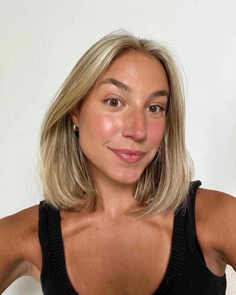 Shoulder length blonde blunt lob with smooth straight texture.