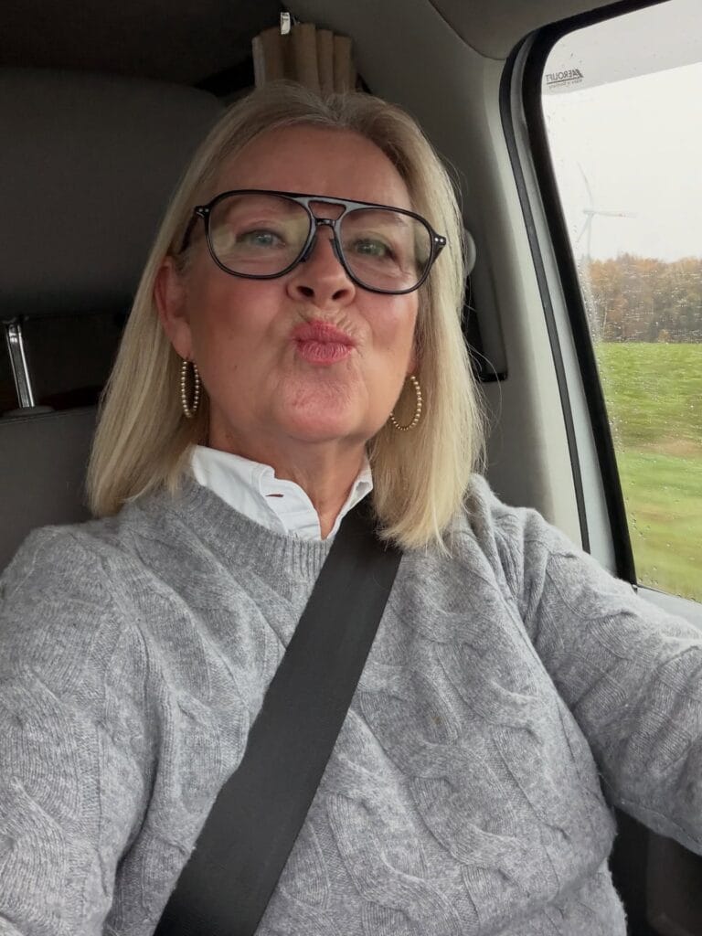 A woman with a straight blonde lob hairstyle styled with minimal layers and a smooth finish.