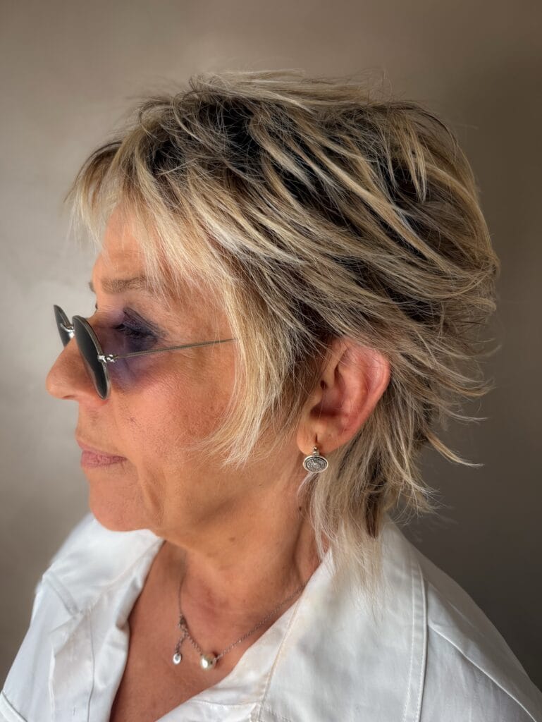 Short textured shag haircut with feathered layers and soft volume for fine hair.