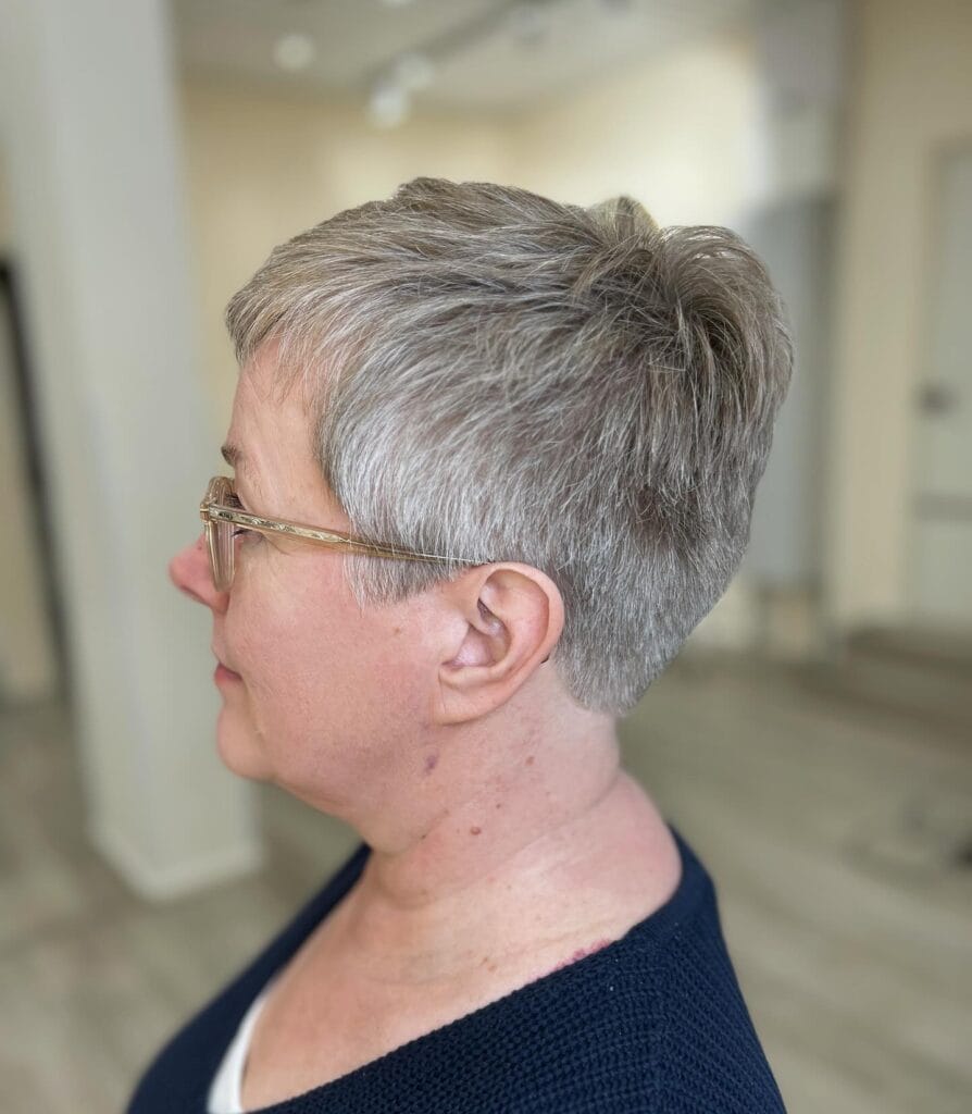 Tapered silver pixie haircut with clean sides and soft volume on top.