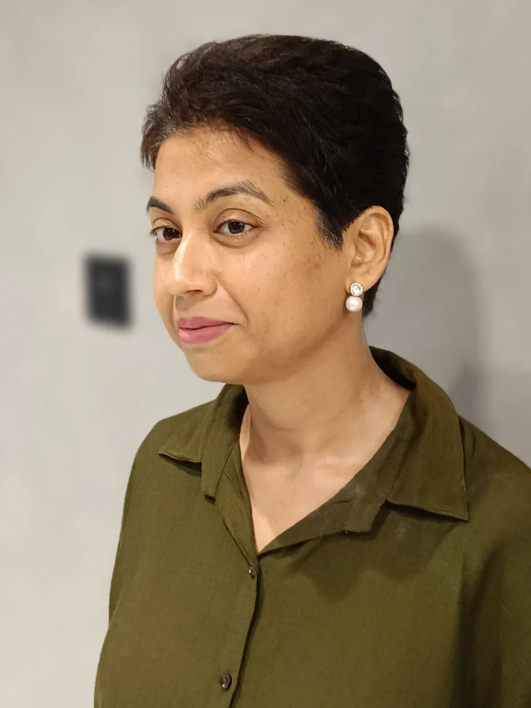 Short cropped pixie haircut with soft volume on top and neatly tapered sides.