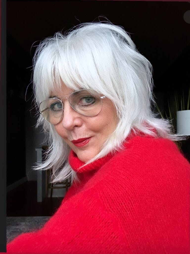 Medium length white hairstyle with feathered layers and soft bangs.