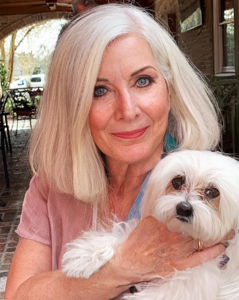 Shoulder length silver bob with smooth straight texture and softly shaped ends.