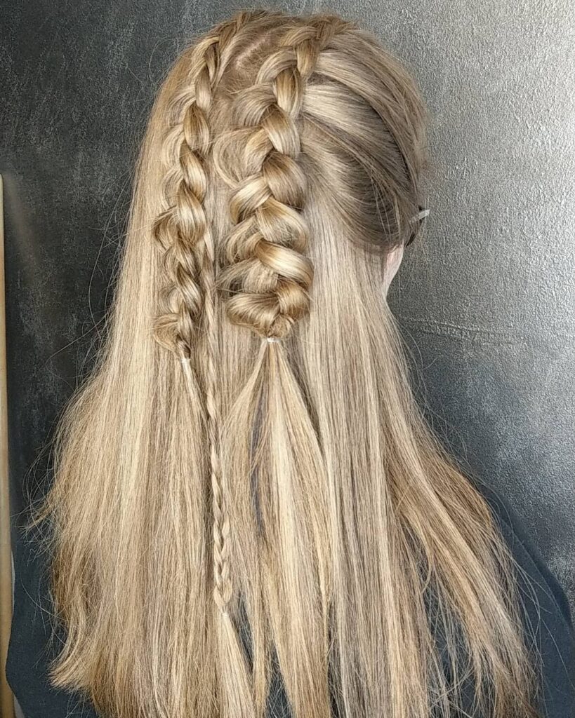Long blonde hair with two small braids at the crown and the rest left straight.