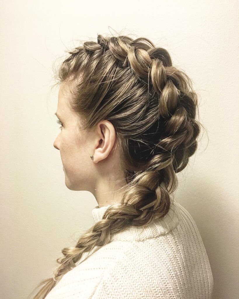Blonde hair styled in a thick crown braid that blends into a loose side braid.