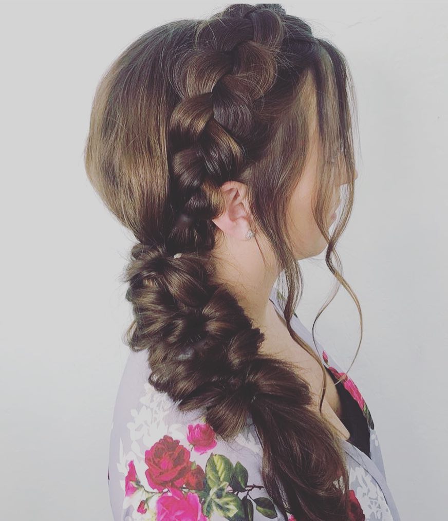 Brown hair styled into a side braid that flows into a bubble ponytail.