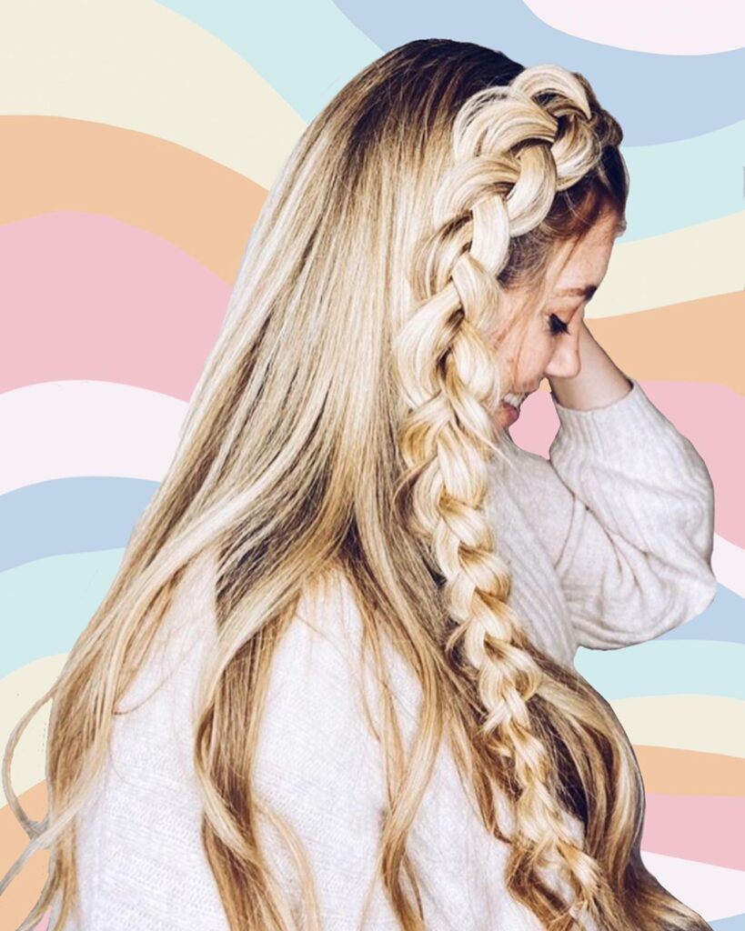 Long blonde hair styled in a chunky side braid over one shoulder.