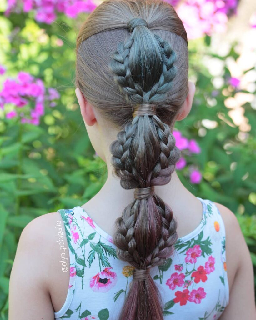 A central bubble braid with multiple small braids woven into each section on medium brown hair.