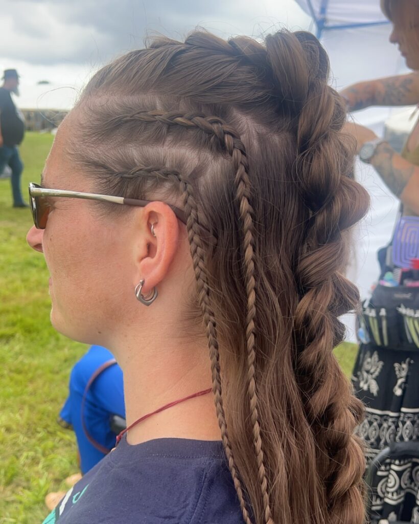 A high bubble braid ponytail with side cornrow braids on medium brown hair.