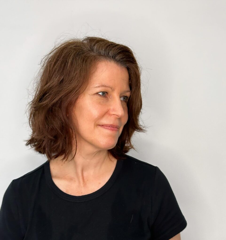 Chestnut brown shag haircut with soft layers and shoulder-length texture.