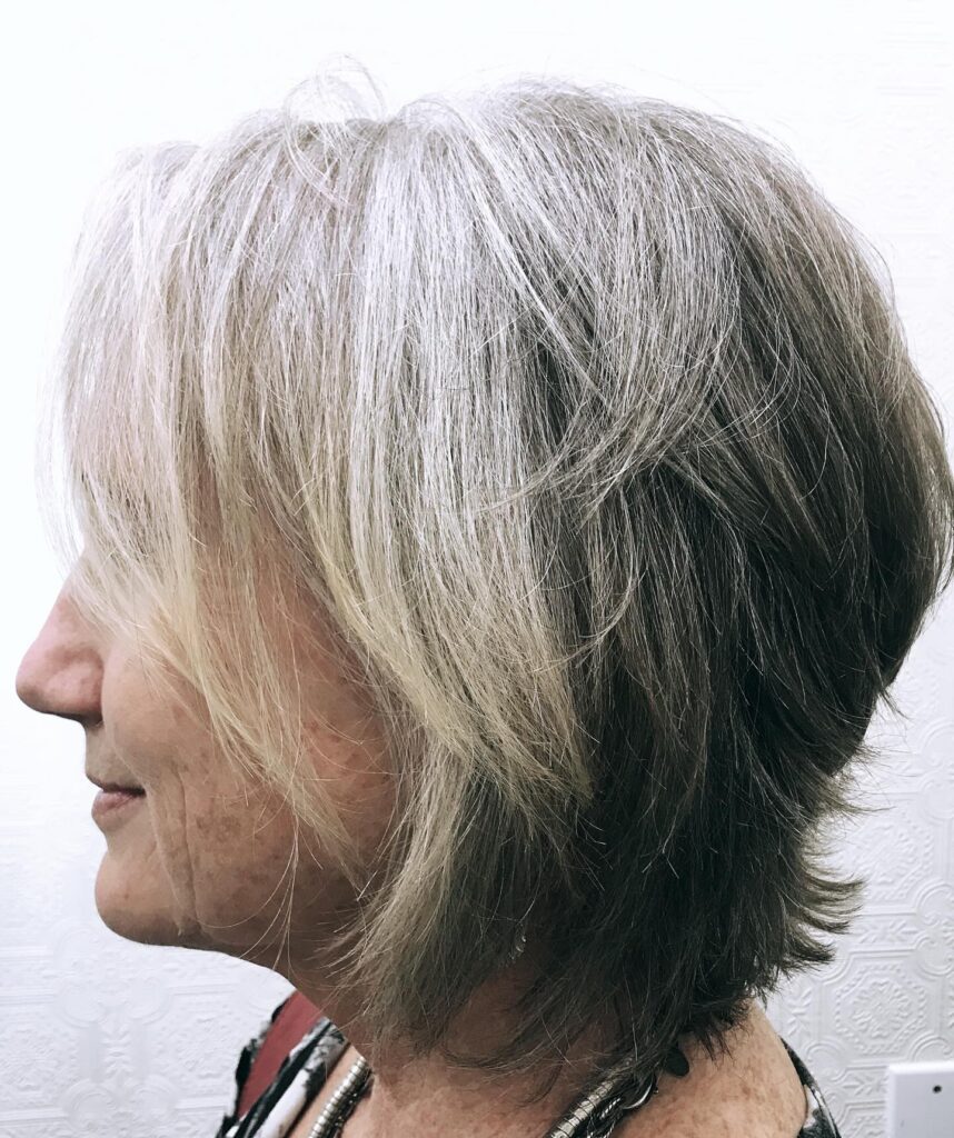 Layered blonde shag haircut with feathered volume and soft textured ends.
