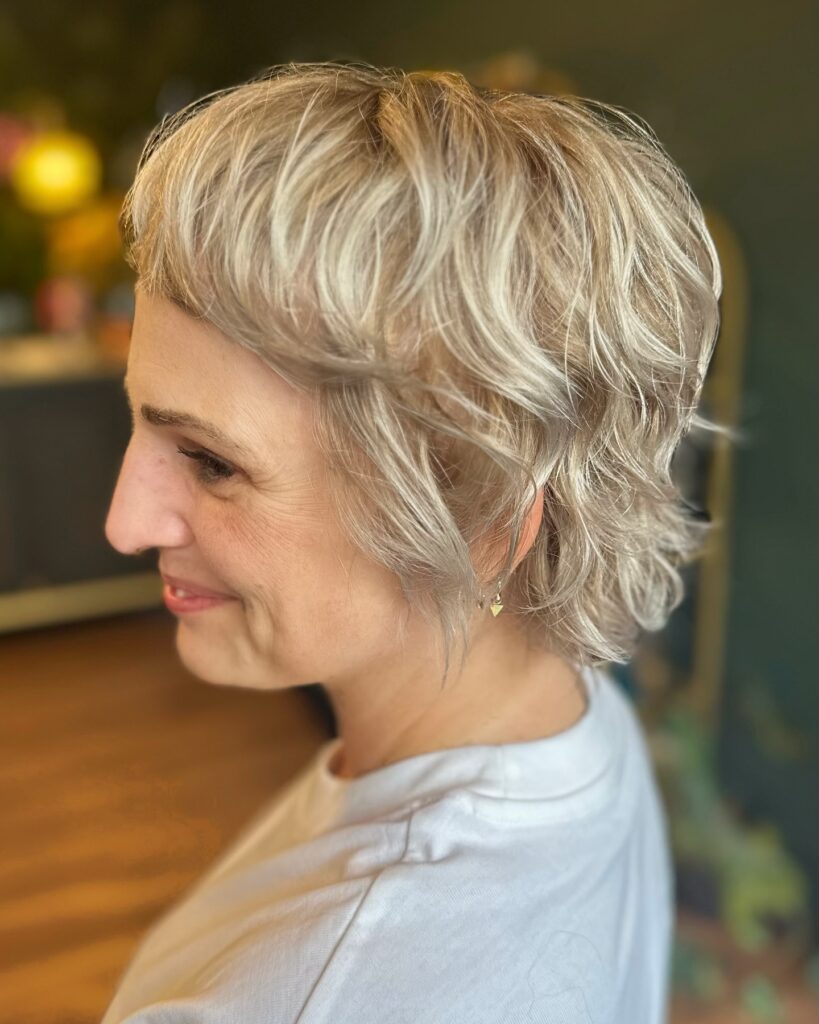 Short platinum pixie bob with tousled layers and feathered texture.