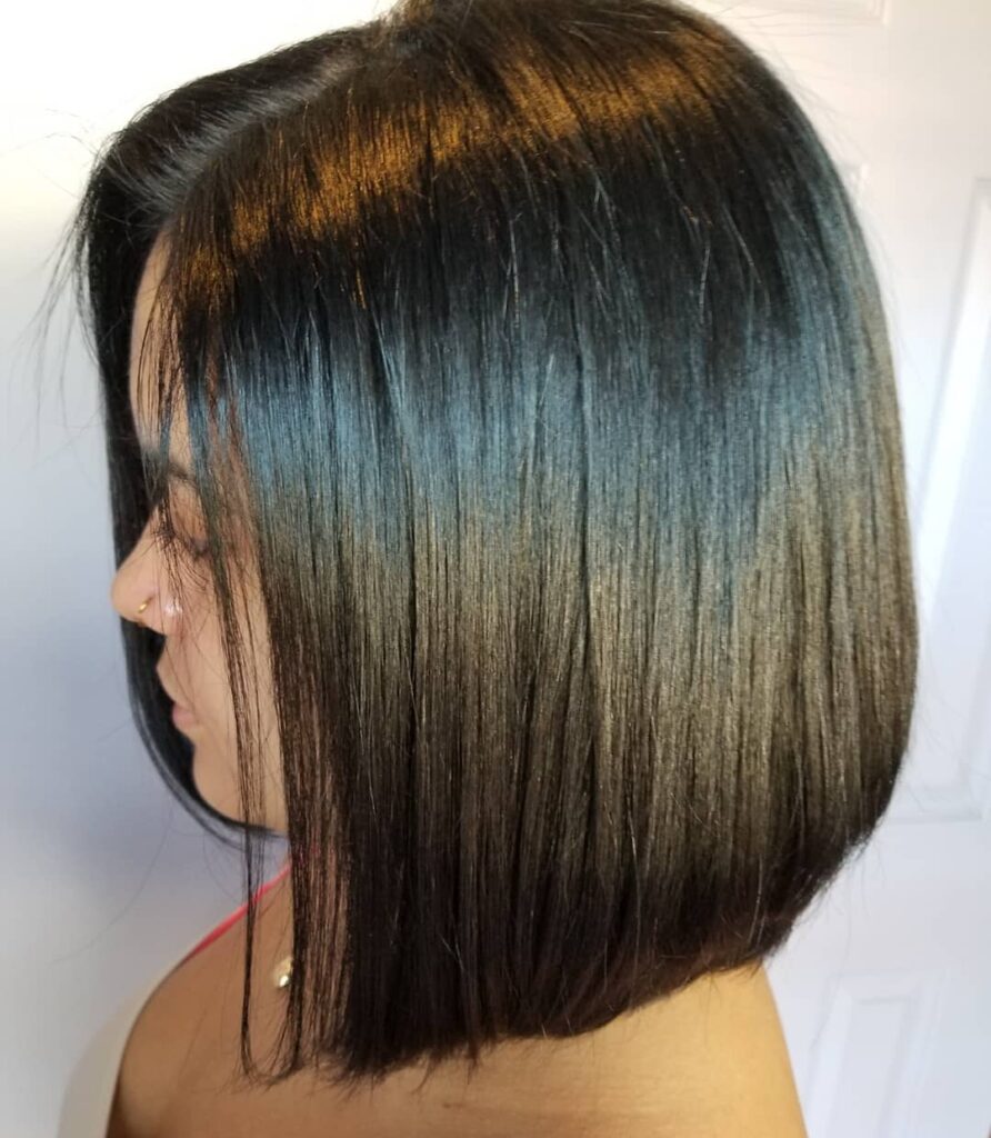 Straight angled black bob with longer front pieces and a sleek glossy finish.