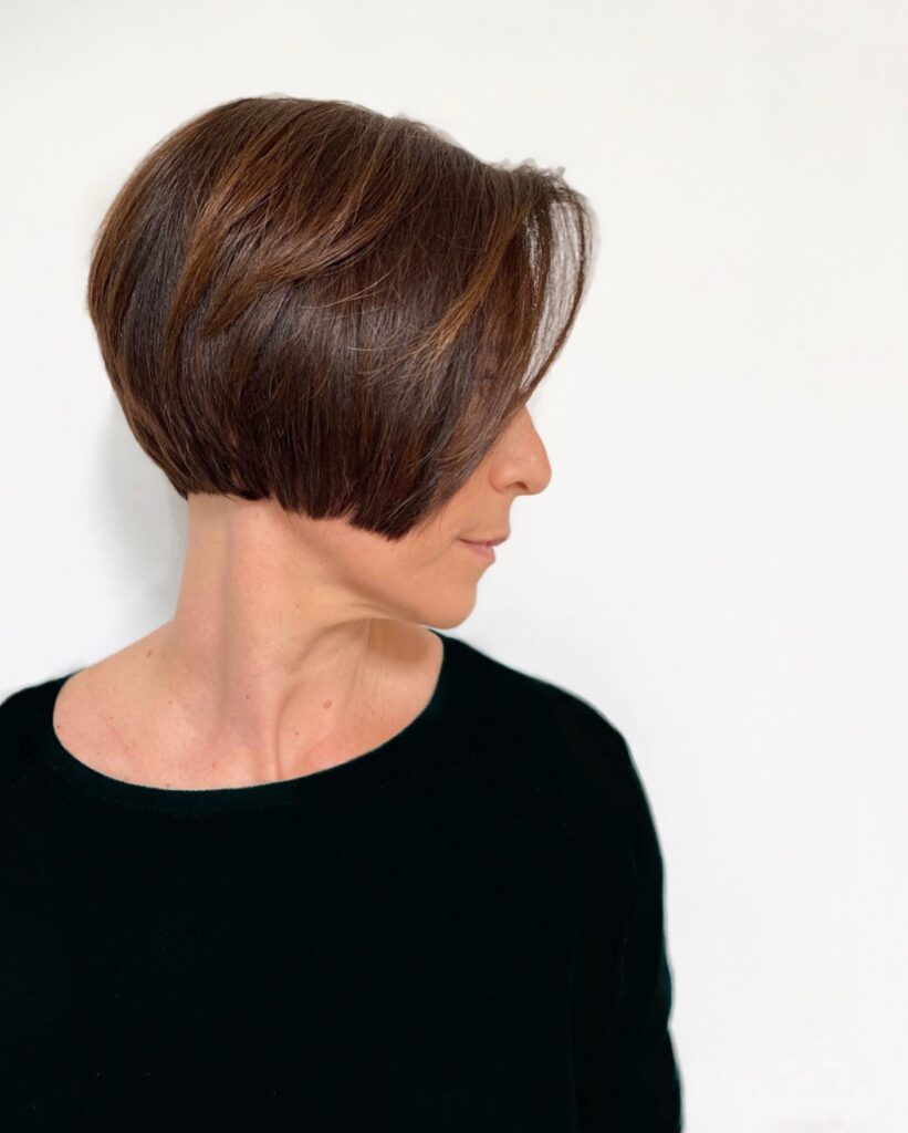 Graduated chestnut brown bob with sleek layers and longer front pieces.