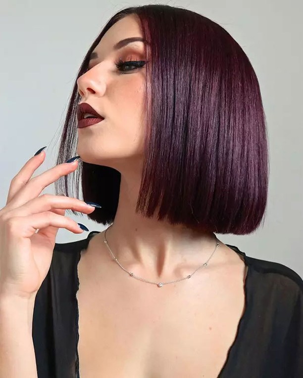 Straight plum colored blunt bob with sleek shiny texture and sharp ends.