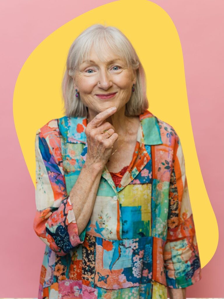 A woman over 60 with a straight silver chin-length bob and soft wispy bangs that rest just above her eyes.